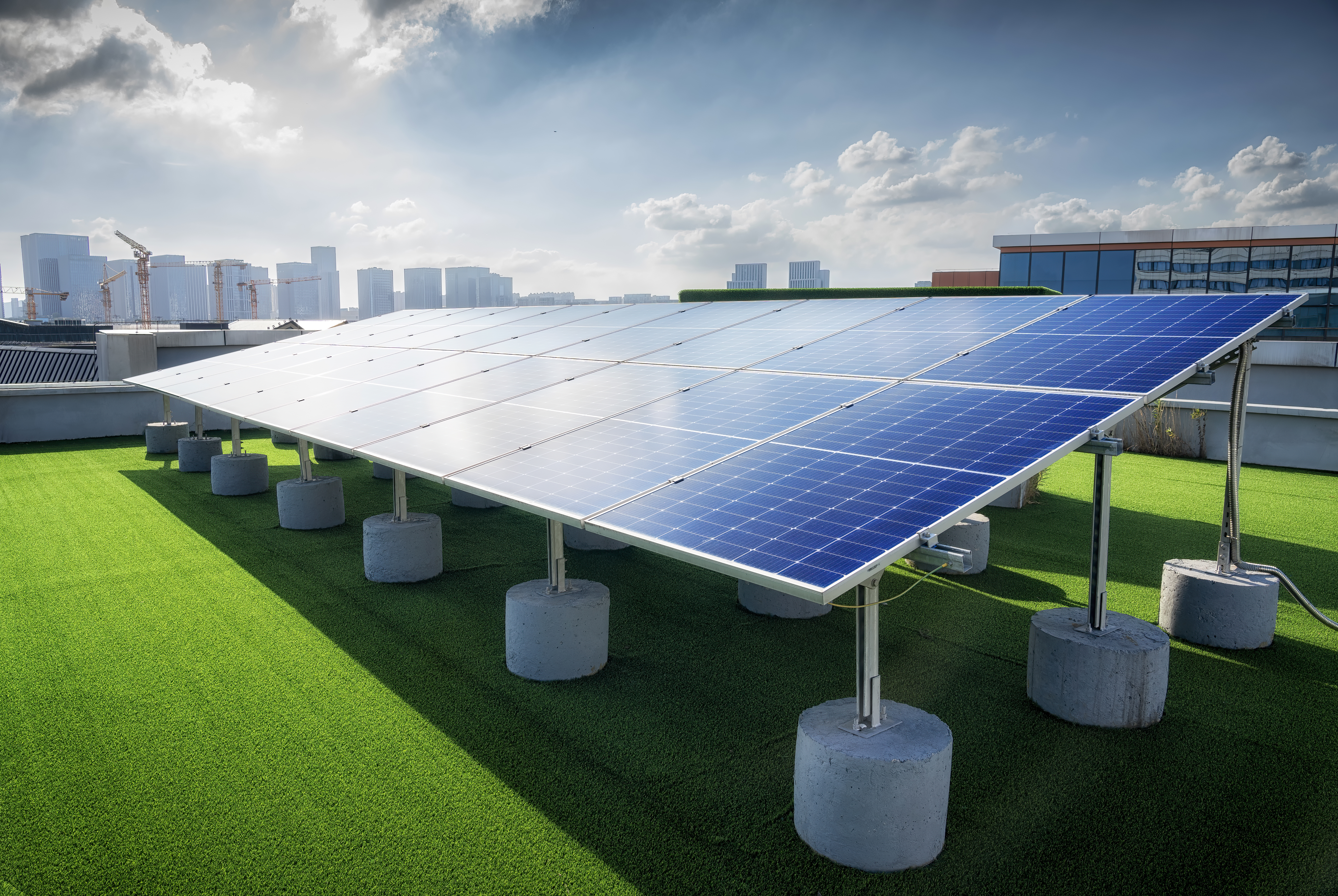 Modern solar panels in front of city